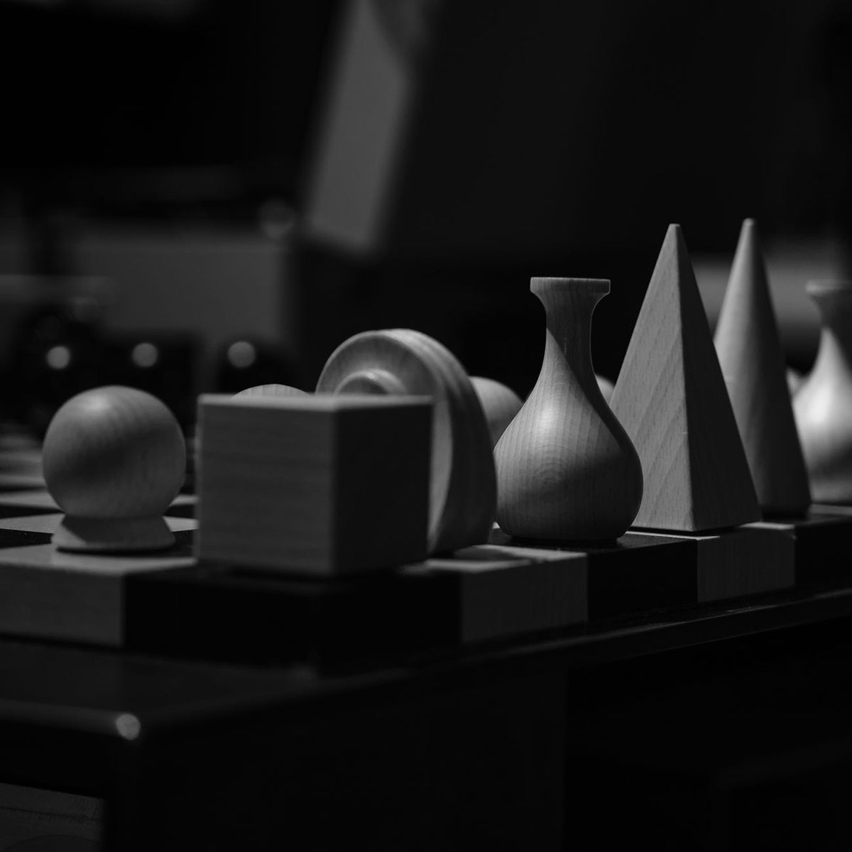 Monochrome display of diverse wooden shapes captured in grayscale for artistic texture exploration.