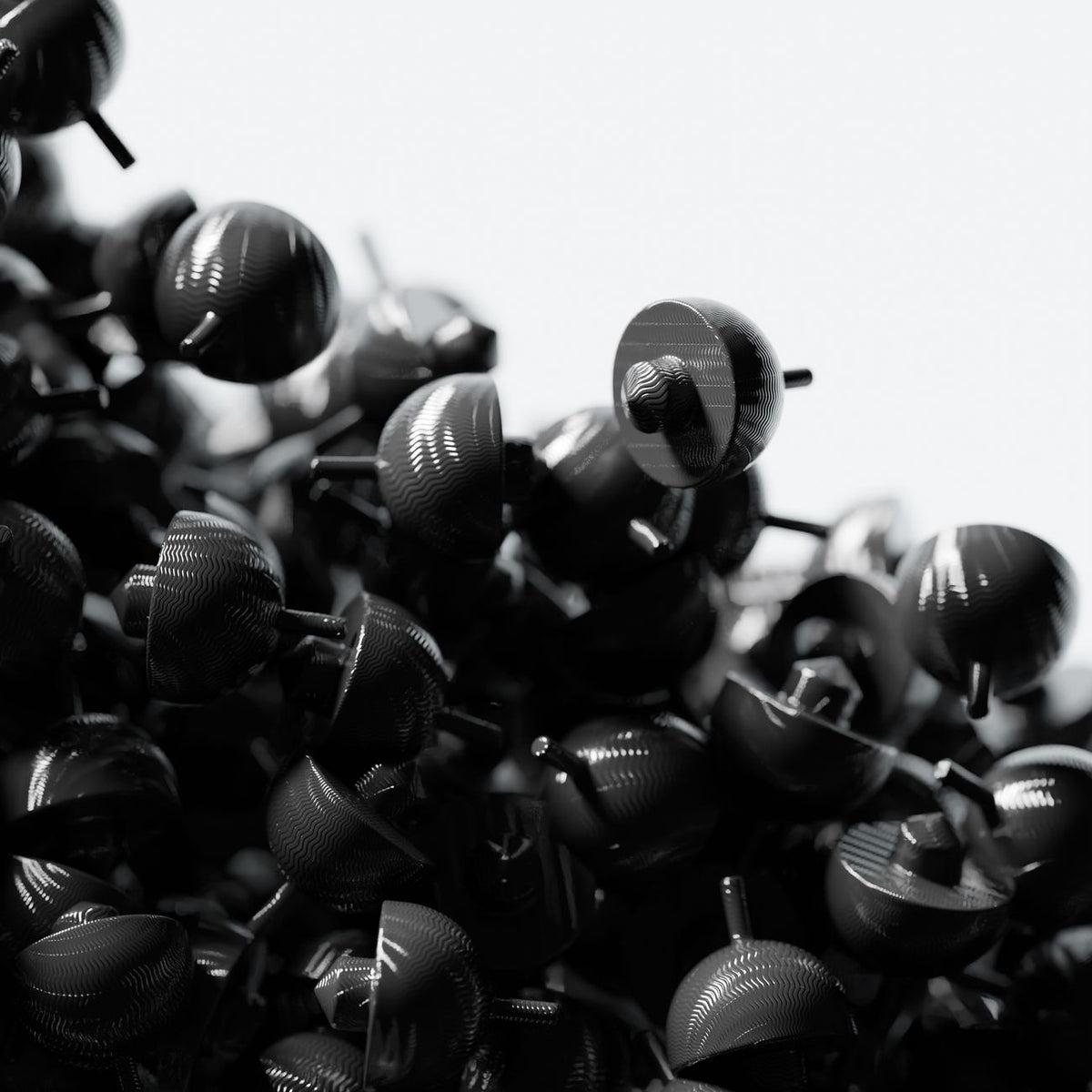 Artistic close-up of black plastic shapes clustered together with glossy finish.