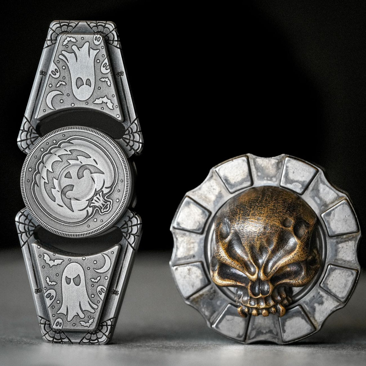 Detailed silver and bronze spinners featuring ghost and skull motifs for collectors.
